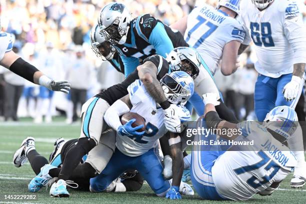 Frankie Luvu of the Carolina Panthers tackles D'Andre Swift of the Detroit Lions during the fourth quarter of the game at Bank of America Stadium on...