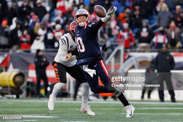 Vonn Bell of the Cincinnati Bengals pressures Mac Jones of the New England Patriots as he attempts a pass during the fourth quarter at Gillette...