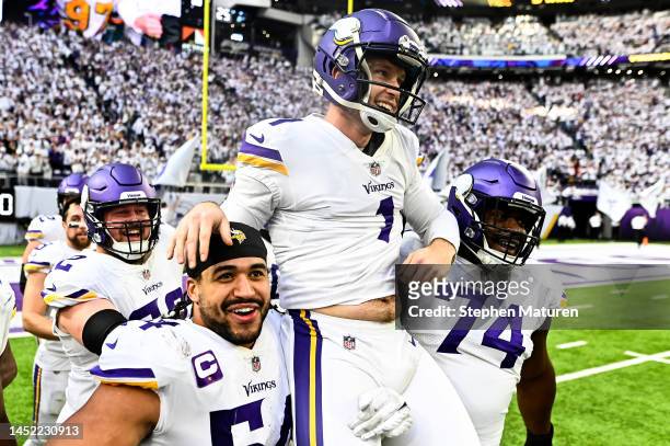 Greg Joseph of the Minnesota Vikings celebrates with teammates after kicking a game winning 61 yard field goal as time expired to beat the New York...