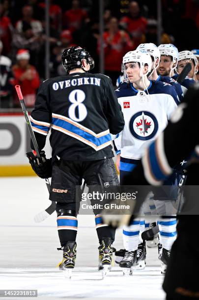 Alex Ovechkin of the Washington Capitals is congratulated after the game by the Winnipeg Jets at Capital One Arena on December 23, 2022 in...
