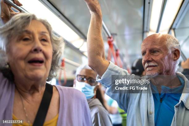 senior friends in the subway train - underground walkway stock pictures, royalty-free photos & images