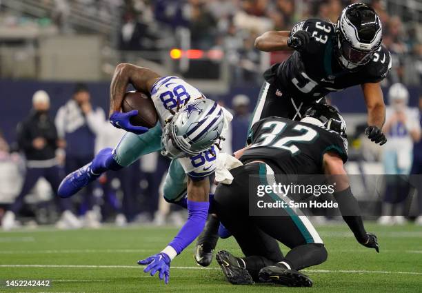 CeeDee Lamb of the Dallas Cowboys runs the ball after a catch and tackled by Reed Blankenship of the Philadelphia Eagles during the first half at...