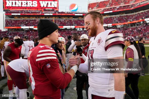 Brock Purdy of the San Francisco 49ers and Carson Wentz of the Washington Commanders embrace after the game at Levi's Stadium on December 24, 2022 in...
