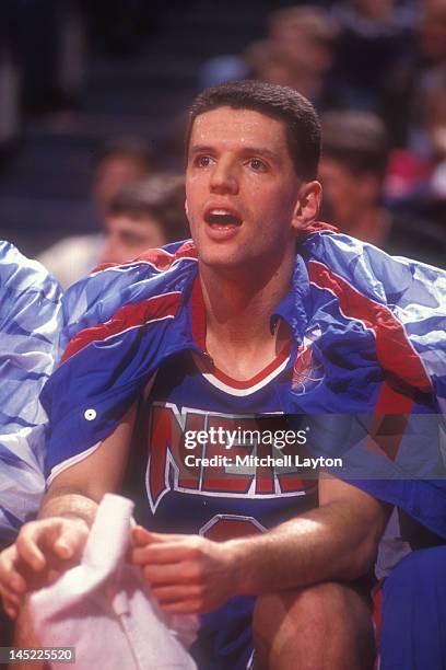 Drazen Petrovic of the New Jersey Nets looks on form the bench during a basketball game against the Washington Bullets at the Capitol Centre on March...