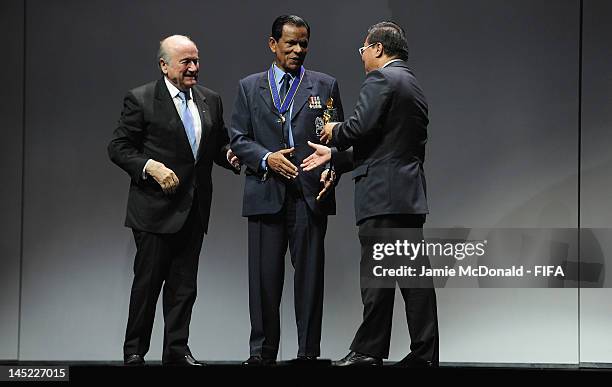 Hari Raij Naicker receives the Order of Merit Award from FIFA President Joseph Sepp Blatter during the 62nd FIFA Congress Opening Ceremony at the...