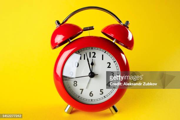 red retro alarm clock on a bright yellow background. the concept of the speed and rapidity of time and the flow of life. copy space. - wind up toy stock pictures, royalty-free photos & images