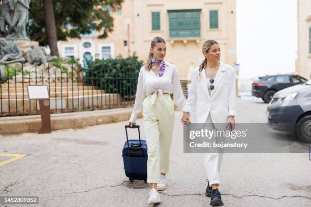 female travelers in old town - malta business stock pictures, royalty-free photos & images