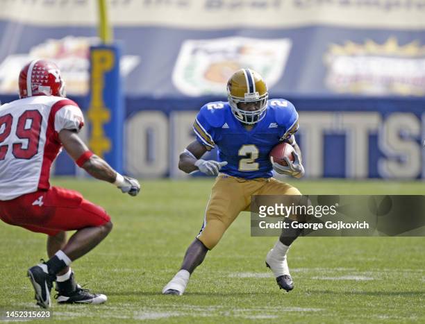 Running back Marcus Furman of the University of Pittsburgh Panthers runs with the football against the Youngstown State Penguins during a college...