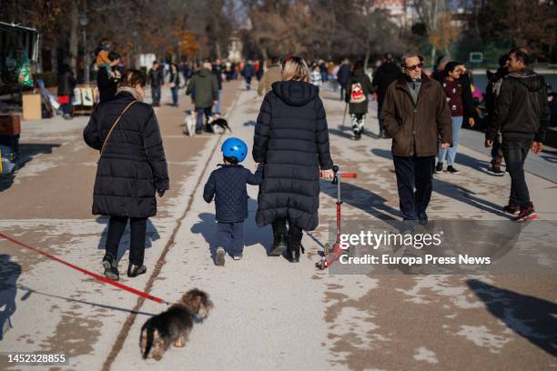 Boy rides his scooter in Retiro Park on December 25 in Madrid, Spain. Toys are the preferred gifts for Santa Claus and the Three Kings and, despite...