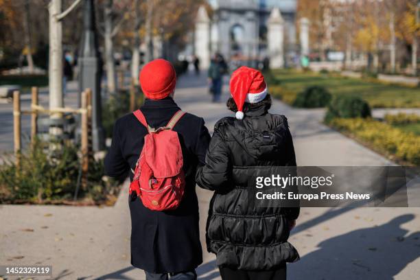 Couple strolls through Retiro Park on December 25 in Madrid, Spain. Toys are the preferred gifts for Santa Claus and the Three Kings and, despite the...