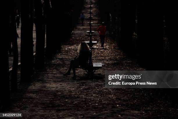 Woman sits on a bench in Retiro Park on Christmas Day, on 25 December, 2022 in Madrid, Spain. Toys are the preferred gifts for Santa Claus and the...