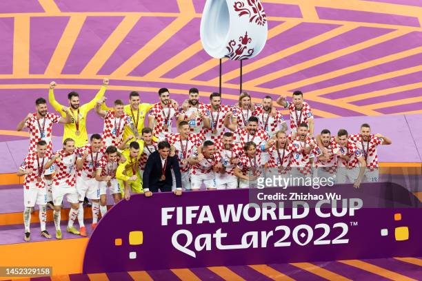 Players of Croatia celebrate the victory during the award ceremony of the FIFA World Cup Qatar 2022 3rd Place match between Croatia and Morocco at...
