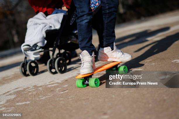 Boy rides a scooter through Retiro Park on December 25 in Madrid, Spain. Toys are the preferred gifts for Santa Claus and the Three Kings and,...