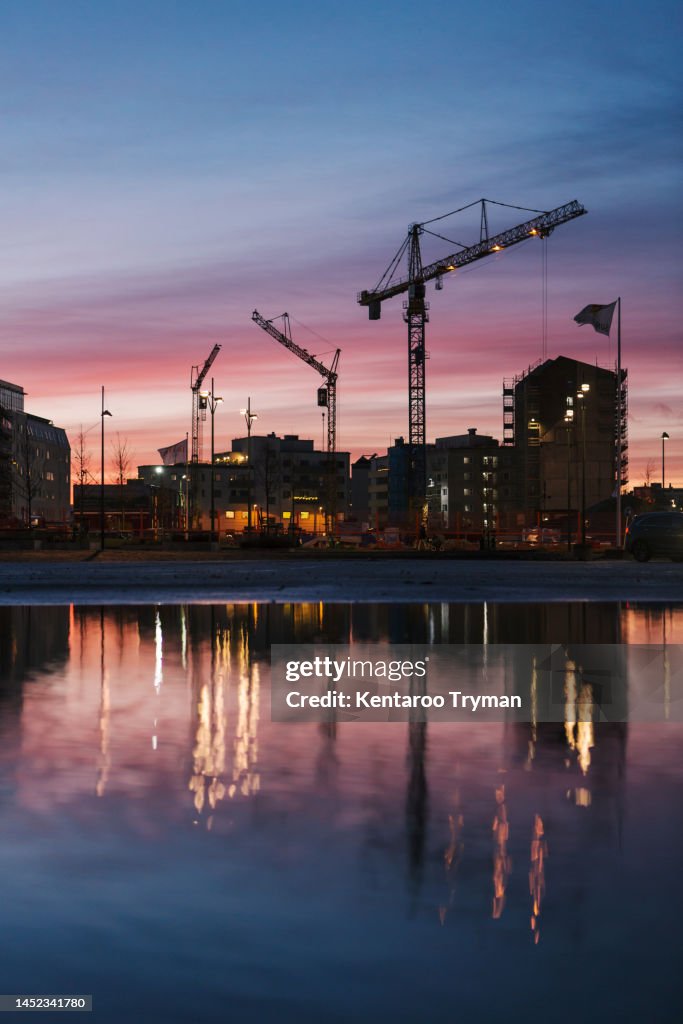 Construction site in a big city in twilight.