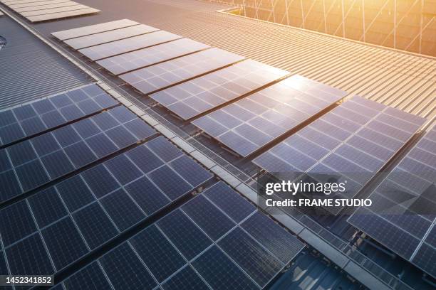 solar panels on the roof of the building a department store by receiving sunlight and storing it in the battery through the inverter to supply electrical energy to the air conditioning and lighting system in the building as clean, pure energy - power line truck stock pictures, royalty-free photos & images