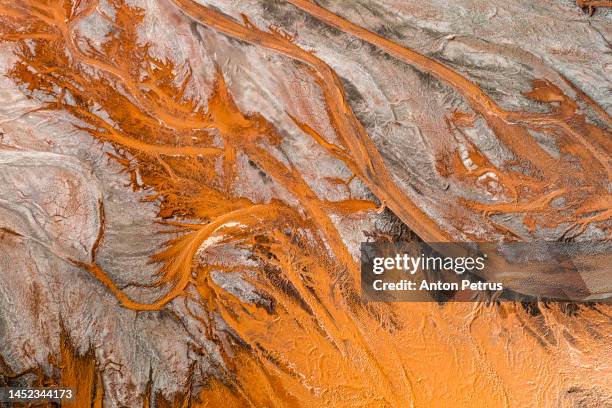 aerial view of a river polluted by waste from metal production - iron ore stock pictures, royalty-free photos & images