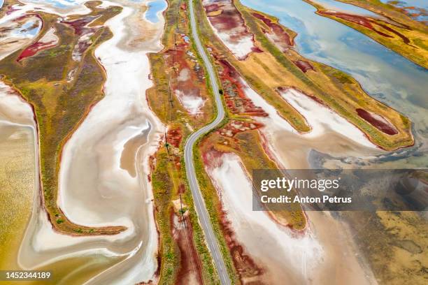 aerial view of road at the salt marsh on the estuary with red grass - anzov stock pictures, royalty-free photos & images