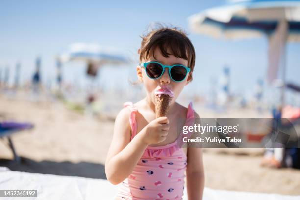 happy summer vacation on the beach. - funny girl eating stock pictures, royalty-free photos & images