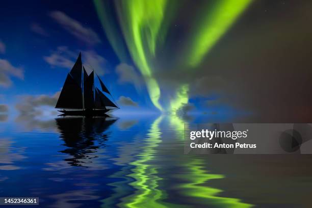 beautiful sailboat in the sea under northern lights - windjammer stock-fotos und bilder