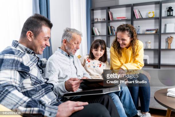 family with  photo album at home - breathing device stock pictures, royalty-free photos & images