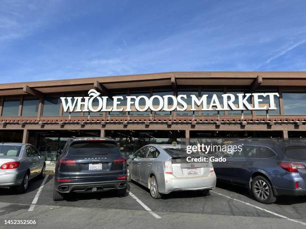 Facade of Whole Foods Market grocery store with cars parked in front on a sunny day in Lafayette, California, November 27, 2022. Photo courtesy Sftm.