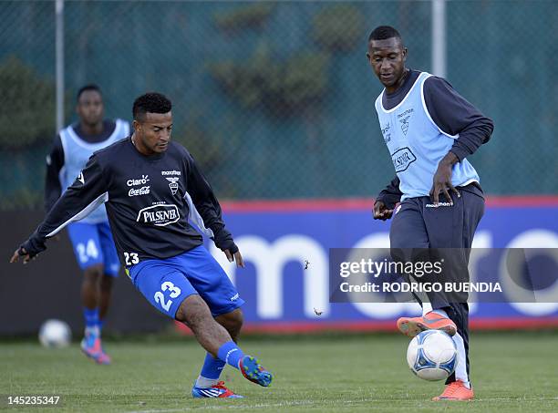 Ecuadorean football players Pedro Quinonez and Jaime Ayovi take part in a training session of the national team in Quito on May 24, 2012. Ecuador...