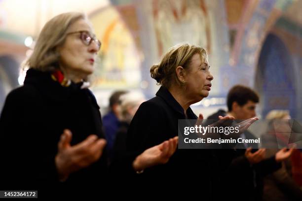 Worshippers pray during the Christmas Eve mass inside the Crypt of the Basilica of Saint Therese of Lisieux on December 24, 2022 in Lisieux, France....