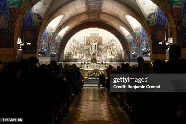 Clergyman leads the Christmas Eve mass inside the Crypt of the Basilica of Saint Therese of Lisieux on December 24, 2022 in Lisieux, France. The...