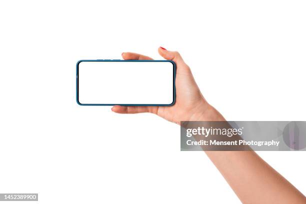 woman hand holding modern frameless smartphone mockup with white screen on white background - querformate stock-fotos und bilder