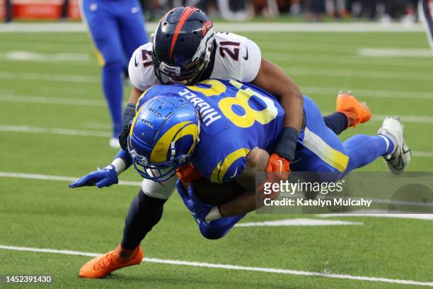 Waun Williams of the Denver Broncos tackles Tyler Higbee of the Los Angeles Rams during the first quarter of the game at SoFi Stadium on December 25,...