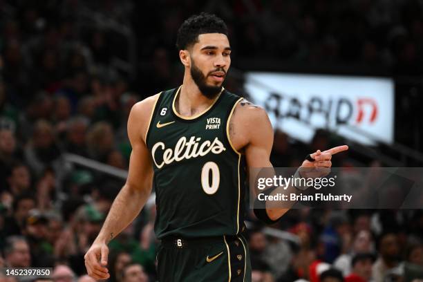 Jayson Tatum of the Boston Celtics reacts after scoring a three-point basket against the Milwaukee Bucks during the third quarter at the TD Garden on...