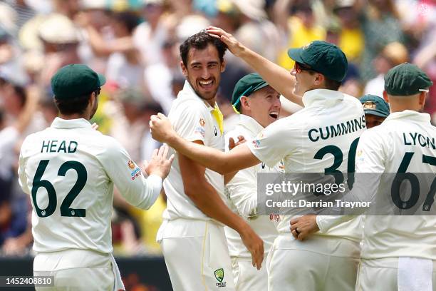 Mitchell Starc of Australia celebrates with team mates after dismissing Temba Bavuma of South Africa during day one of the Second Test match in the...
