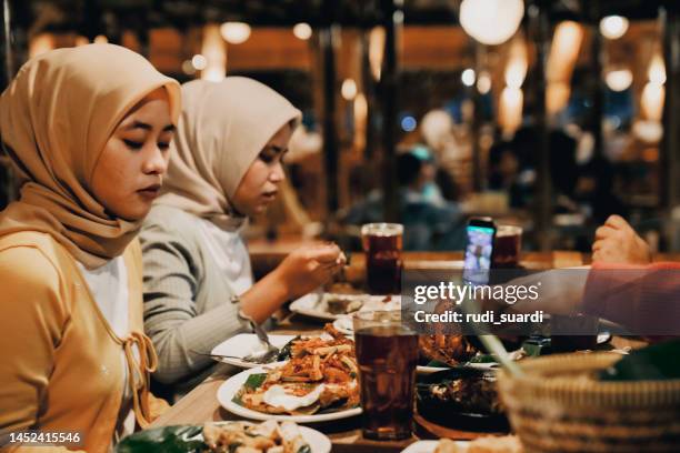 deux femmes dînant au restaurant - iftar photos et images de collection