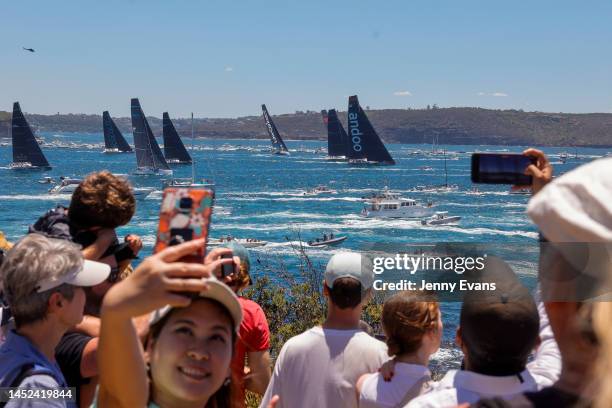 Woman takes a selfie as the fleet advance towards The Heads during the 2022 Sydney to Hobart on Sydney Harbour, on December 26, 2022 in Sydney,...