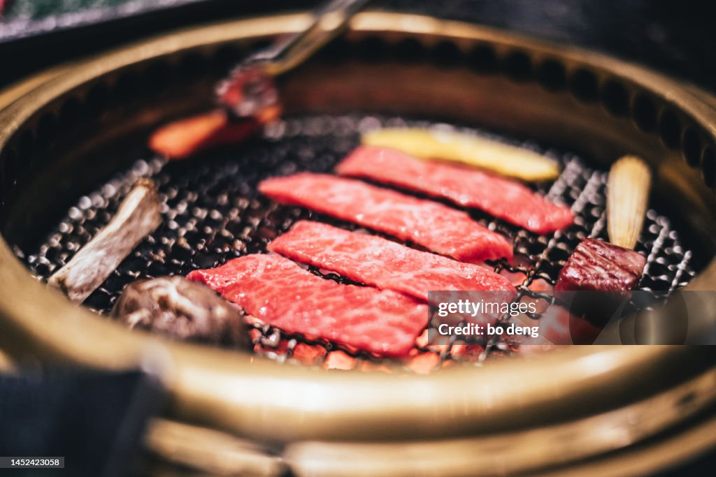 Raw Beef being grilled in Korean Barbeque grill