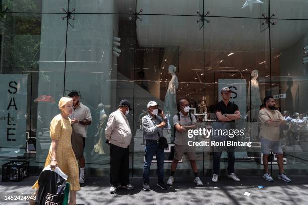 Shoppers are seen outside a shop at Pitt Street Mall during Boxing Day sales on December 26, 2022 in Sydney, Australia. Retailers offer massive...