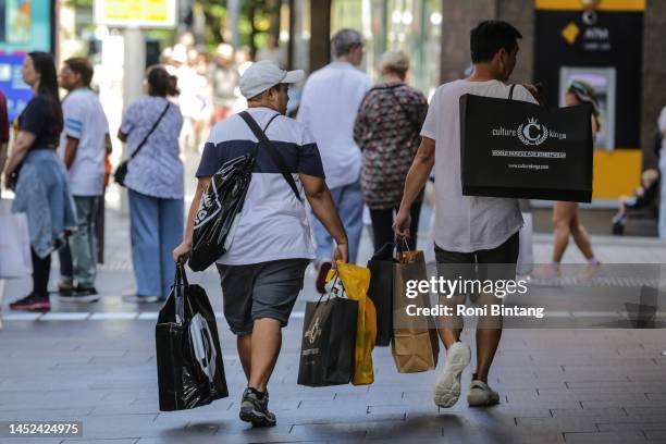 People carry shopping bags at Market Street on Boxing day on December 26, 2022 in Sydney, Australia. Retailers offer massive discounts and enticing...