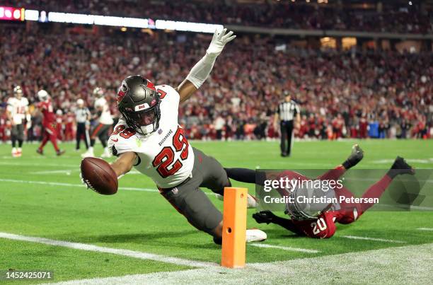 Rachaad White of the Tampa Bay Buccaneers stretches across the goal line for a touchdown as Marco Wilson of the Arizona Cardinals defends during the...