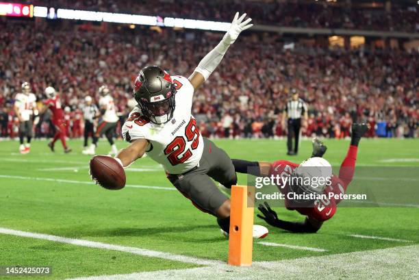 Rachaad White of the Tampa Bay Buccaneers stretches across the goal line for a touchdown as Marco Wilson of the Arizona Cardinals defends during the...