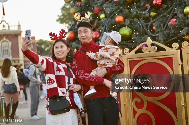 People pose for selfies at Hong Kong Disneyland Resort on Christmas on December 25, 2022 in Hong Kong, China.