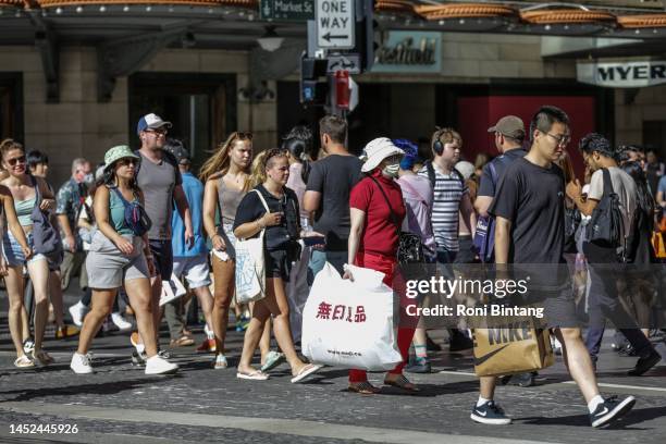 People walk along George Street on Boxing Day on December 26, 2022 in Sydney, Australia. Retailers offer massive discounts and enticing deals on the...