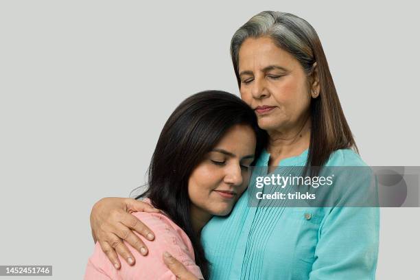 happy mother and daughter embracing each other - mother in law stock pictures, royalty-free photos & images