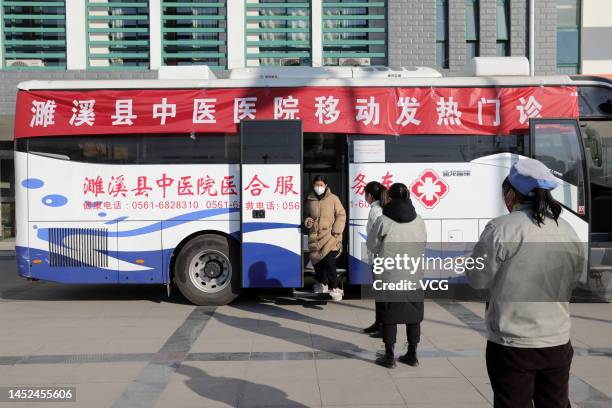 Patients wait outside medical service bus to get treatment on December 25, 2022 in Huaibei, Anhui Province of China.