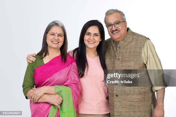 cheerful old parents with adult daughter on white background - indian elderly couple stock pictures, royalty-free photos & images