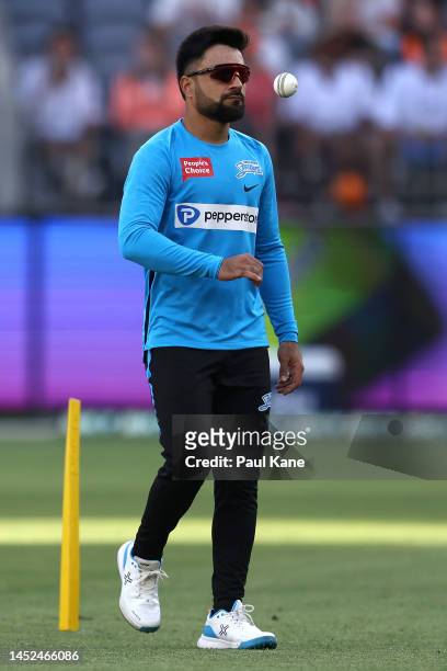 Rashid Khan of the Strikers looks on while warming before the Men's Big Bash League match between the Perth Scorchers and the Adelaide Strikers at...