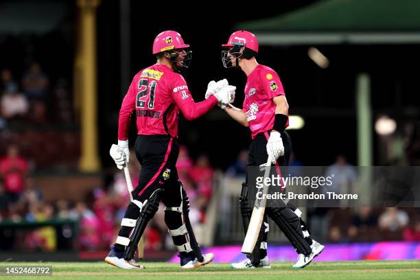 Moises Henriques and Jordan Silk of the Sixers shake hands during the Men's Big Bash League match between the Sydney Sixers and the Melbourne Stars...