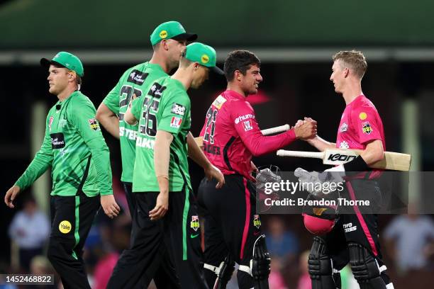 Moises Henriques and Jordan Silk of the Sixers celebrate during the Men's Big Bash League match between the Sydney Sixers and the Melbourne Stars at...
