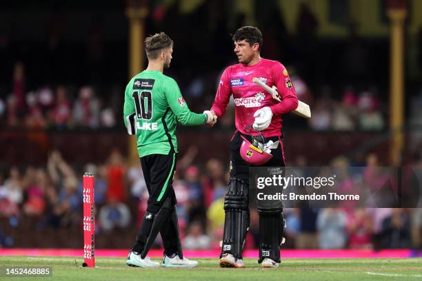 Moises Henriques of the Sixers shakes hands with Joe Clarke of the Stars during the Men's Big Bash League match between the Sydney Sixers and the...