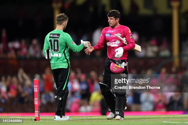 Moises Henriques of the Sixers shakes hands with Joe Clarke of the Stars during the Men's Big Bash League match between the Sydney Sixers and the...