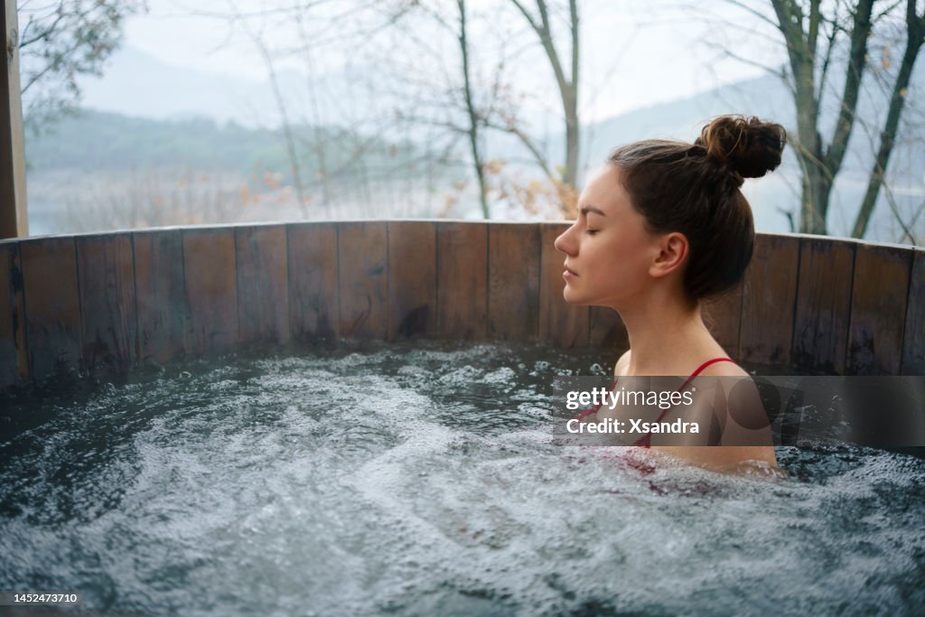 Woman relaxing in the outdoor hot tub